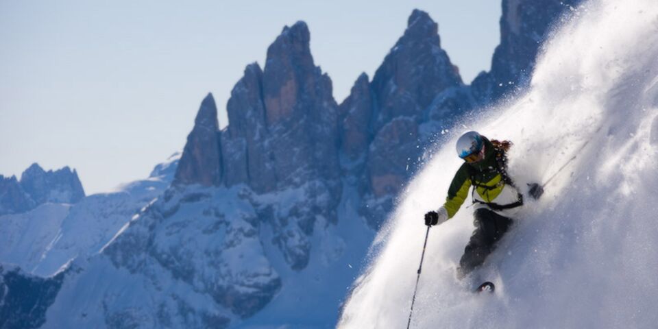 Luke skiing deep powder in the Dolomites